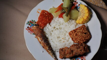white rice with side dishes of fried salted fish and tamarind vegetables