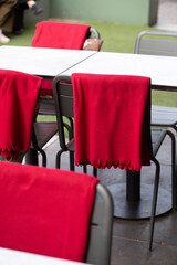 Red blankets in outdoor cafe area.
