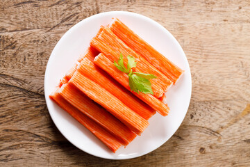 Crab sticks on white plate.