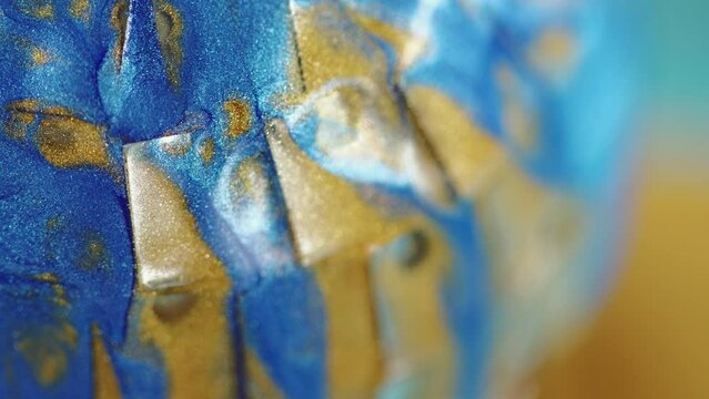 Glitter ink texture. Fluid flow. Defocused blue golden color gradient paint blend wave motion art abstract free space background.