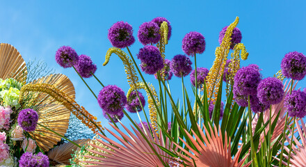 A bouquet of purple flowers against a blue sky - Powered by Adobe