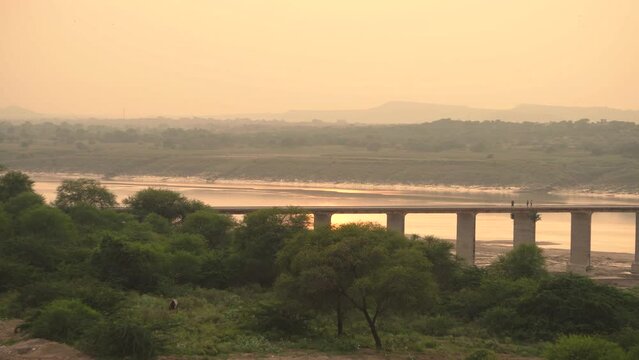 Pan shot of an old abandoned bridge on Chambal river during sunset in Dholpur India