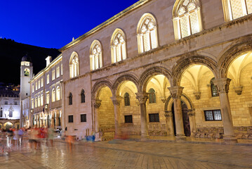 Fototapeta na wymiar Ancient street in Dubrovnik illuminated at dusk with Rector Palace on the foreground, Croatia