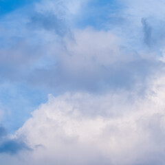 Blue sky background with white and pink clouds at sunset