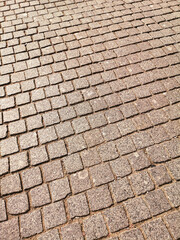 Paving stones on the road as an abstract background. Texture