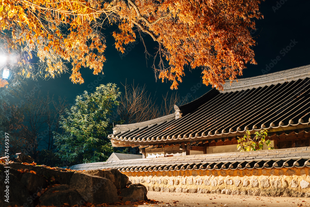 Poster night view of gyochon hanok village at autumn in gyeongju, korea