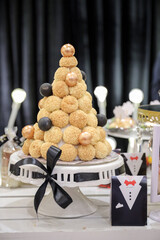 Delicious wedding reception or sweet seventeenth birthday party candy bar sweet dessert table with various sweets, cupcakes, macarons, fruits and pies.