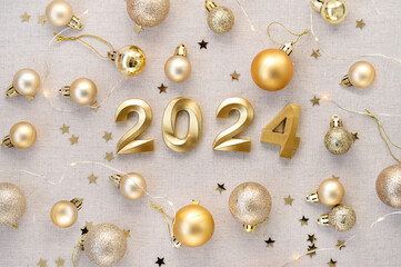 New Year 2024 celebration concept. Number 2024, golden decoration Christmas balls and confetti stars pattern on neutral beige linen background. Festive holiday backdrop, banner design template