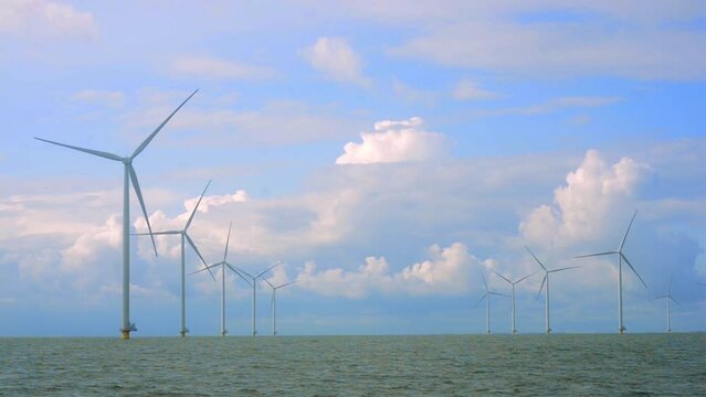 Off shore wind park with storm clouds in the sky.