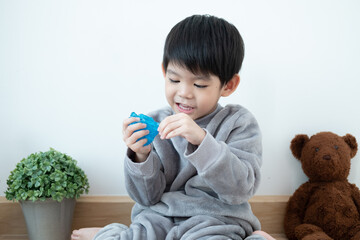 Asian boy having fun playing slam on the floor Learning outside the classroom