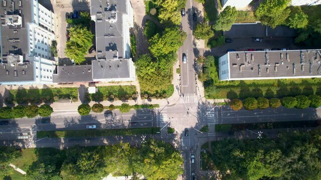 Summer Car Traffic on Crossroad in Residential District by Park Centralny in Gdynia City  - aerial top down flying