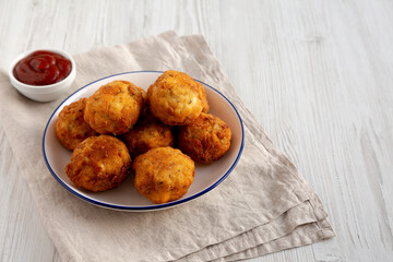 Homemade Cheesy Chicken Nuggets with Ketchup, side view. Copy space.
