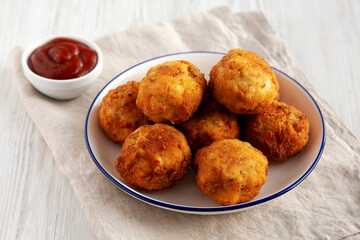 Homemade Cheesy Chicken Nuggets with Ketchup, side view.