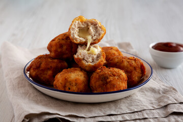 Homemade Cheesy Chicken Nuggets with Ketchup, side view.