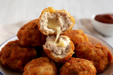 Homemade Cheesy Chicken Nuggets with Ketchup, side view.