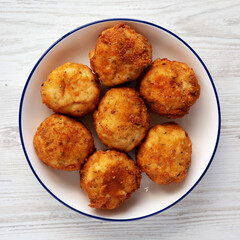 Homemade Cheesy Chicken Nuggets on a Plate, top view. Overhead, from above, flat lay.