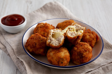 Homemade Cheesy Chicken Nuggets with Ketchup, low angle view.