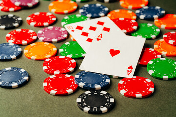 Playing cards and chips on green background