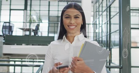 Animation of graphs, loading bars, circles over smiling biracial woman holding files and cellphone - Powered by Adobe