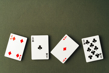 Playing cards on green background studio shot