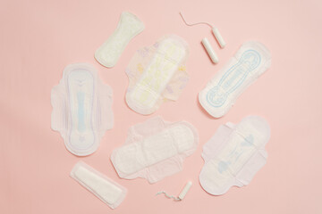 Different feminine sanitary napkins (sanitary pads) with tampon on pink background