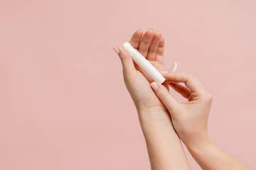Medical feminine tampon in hand. Cotton swab. Menstruation - obrazy, fototapety, plakaty