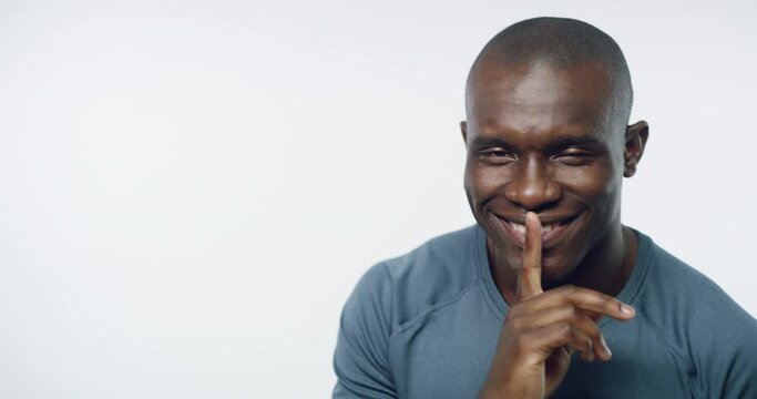 African man, studio and finger on lips with smile on face for training secret, fitness or health by white background. Personal trainer, sign language or icon for silence, promotion or deal for gym