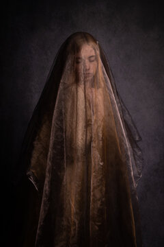 solemn art portrait of woman  under golden veil in renaissance style