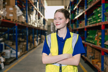 Portrait smart worker confident young teen female work inside warehouse industry inventory management happy smiling.