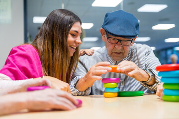 Man and nurse playing board game in a nursing home
