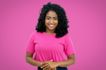Beautiful mexican young adult woman on pink background
