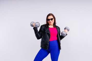 Sporty model with curvy figure with dumbbells. Dynamic movement. Motivation and healthy lifestyle