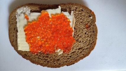 sandwich with black bread, butter and red caviar, food snack, breakfast