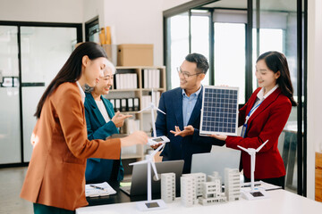 Discussion among Asian businesspeople on the latest developments in solar cell panel technology and Solar Energy Environment city Concept..