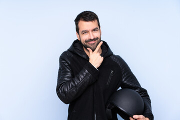 Man with a motorcycle helmet over isolated background smiling