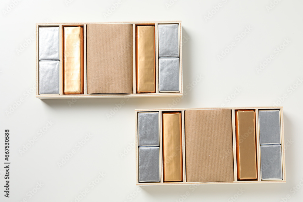 Wall mural chocolate candies in boxes on white background, top view