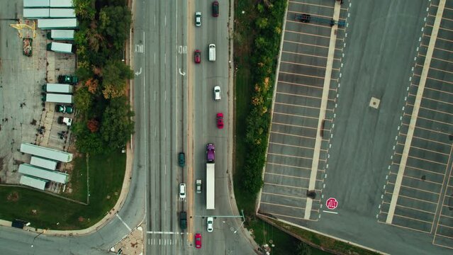 top down Purple dry van reefer CDL truck driver. Aerial shot of semi tractor navigating city roads, highlighting the essential role of freight transport in urban settings. Chicago area