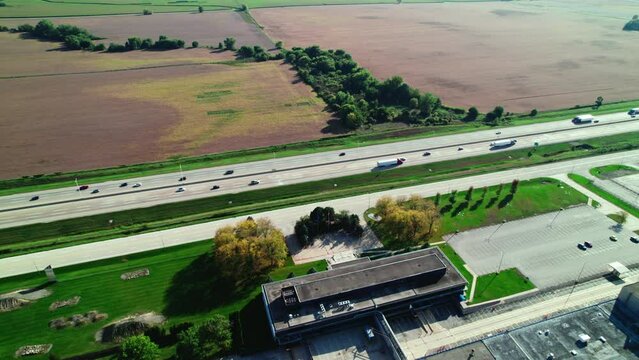 Many trucks on highway I-90. Dry vans, reefers, flatbeds, stepdecks semi tractor and trailers with CDL truck drivers who are proud that hauls freight in america. Trucking business.