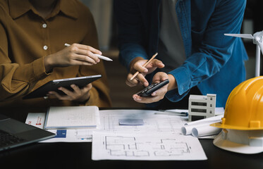 brainstorming and measuring for cost estimating on paperworks and floor plan drawings about design architectural and engineering for houses and buildings. - obrazy, fototapety, plakaty
