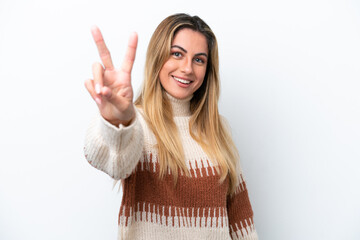 Young caucasian woman isolated on white background smiling and showing victory sign - obrazy, fototapety, plakaty
