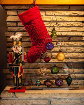 red christmas stocking with nutcracker and ornaments