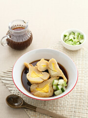 Pempek Palembang, traditional food from South Sumatra, Indonesia. This fish-based food is very popular. Served with cuko sauce and cucumber slices.
