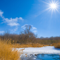 frozen river at the sunny winter day