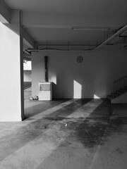 Interior view of a building with a high ceiling, in grayscale
