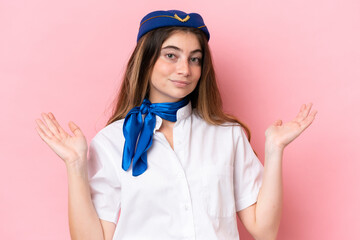 Airplane stewardess caucasian woman isolated on pink background having doubts and with confuse face...