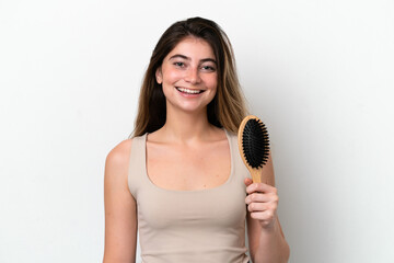 Young woman with hair comb isolated on white background smiling a lot