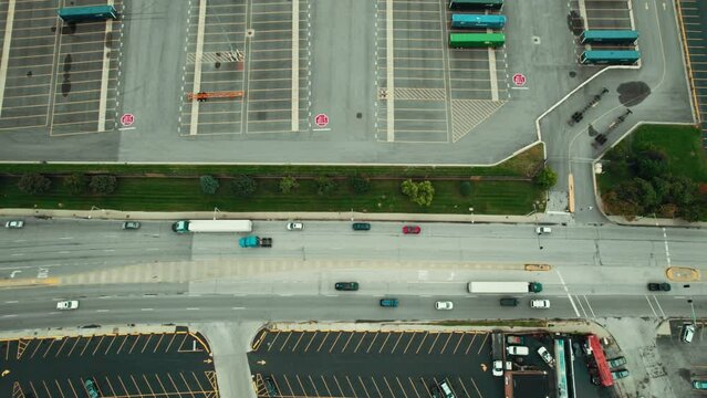 top down tracking aerial of a local green semi tractor and trailer. CDL driver job