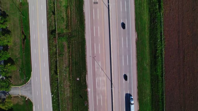 top down aerial of semi truck dry van driving on interstate in america