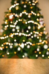 Christmas table background with christmas tree bokeh	