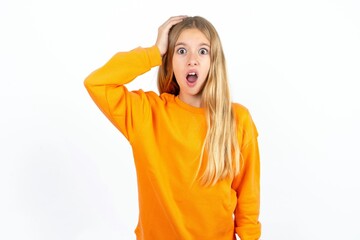Embarrassed Beautiful teen blonde girl  with shocked expression, expresses great amazement, Puzzled...
